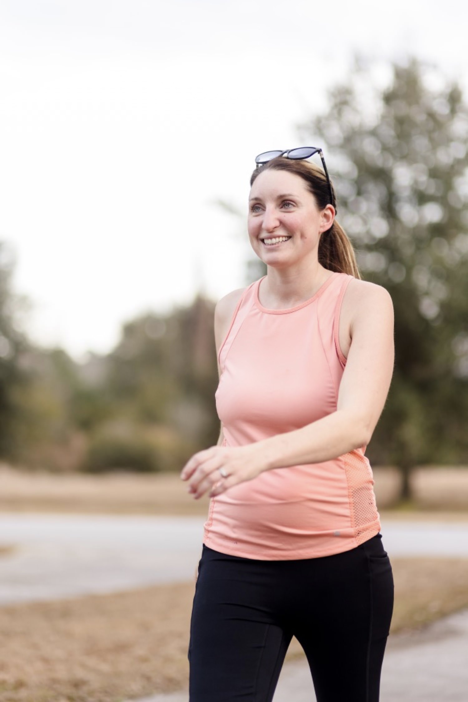 sarah in a pink tank top walking outside